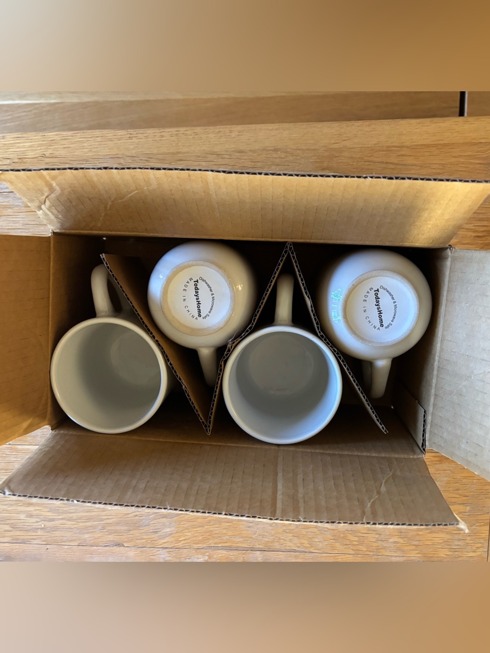 Set of four white ceramic mugs